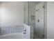 Bathroom with neutral tile, soaking tub and shower with glass enclosure at 2316 Pine Bluff Ct, Las Vegas, NV 89134
