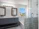 Bathroom featuring double sink vanity with two mirrors, shower, bathtub and updated fixtures at 2316 Pine Bluff Ct, Las Vegas, NV 89134