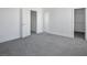 Neutral bedroom featuring a neutral carpet, walk-in closet, and plenty of natural light at 2316 Pine Bluff Ct, Las Vegas, NV 89134