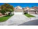 Front exterior features a spacious driveway and a two-car garage at 2316 Pine Bluff Ct, Las Vegas, NV 89134