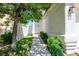 A walkway leads to the front door, framed by a beautiful tree and lush landscaping at 2316 Pine Bluff Ct, Las Vegas, NV 89134