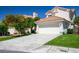The home features a tile roof, a two-car garage, and a lush green lawn at 2316 Pine Bluff Ct, Las Vegas, NV 89134
