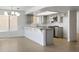 A spacious kitchen with granite countertops, modern appliances, and stylish lighting at 2316 Pine Bluff Ct, Las Vegas, NV 89134