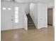 A bright living room features tile floors, a staircase, and a view to the front door at 2316 Pine Bluff Ct, Las Vegas, NV 89134