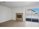 Living room with modern fireplace and sliding glass doors leading to the backyard at 2316 Pine Bluff Ct, Las Vegas, NV 89134