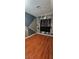 Stylish bedroom with geometric accent wall, hardwood floors, and window with black curtains at 236 N Bruce St # C, Las Vegas, NV 89101