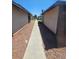 Exterior view between homes featuring gravel and a concrete walkway at 236 N Bruce St # C, Las Vegas, NV 89101