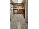 Functional kitchen featuring wooden cabinets, white appliances, and tiled flooring at 236 N Bruce St # C, Las Vegas, NV 89101