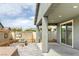 Cozy covered patio with a fireplace and spa in the backyard at 2395 Arrington Ave, North Las Vegas, NV 89086