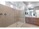 Modern bathroom featuring a glass-enclosed shower with dual shower heads, and dual sink vanity at 2395 Arrington Ave, North Las Vegas, NV 89086