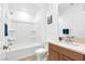 Bathroom with white tiled shower and tub, toilet and vanity at 2395 Arrington Ave, North Las Vegas, NV 89086