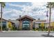 Elegant clubhouse exterior with stone accents, lush landscaping, and an American flag at 2395 Arrington Ave, North Las Vegas, NV 89086