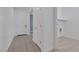 Hallway with tiled flooring, white walls, and a doorway to a laundry room at 2395 Arrington Ave, North Las Vegas, NV 89086