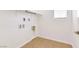 A simple, bright laundry room with tile floor and hookups at 2395 Arrington Ave, North Las Vegas, NV 89086