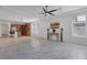 Bright living room with tile flooring and open layout flowing to the kitchen at 2395 Arrington Ave, North Las Vegas, NV 89086