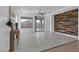 Bright living room with decorative wood wall, tile floors, and sliding glass doors to backyard at 2395 Arrington Ave, North Las Vegas, NV 89086