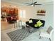 Inviting living room featuring tile floors, a modern ceiling fan, and an open floor plan at 2395 Arrington Ave, North Las Vegas, NV 89086