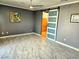 Main bedroom with tile flooring, neutral walls, a ceiling fan, and barn door access to bathroom at 2395 Arrington Ave, North Las Vegas, NV 89086