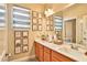 Bright bathroom featuring a double vanity with sconce lighting and decorative wall art above at 2497 Birch Hollow St, Henderson, NV 89044