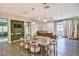 Light-filled dining area with a large wooden table and comfortable seating at 2497 Birch Hollow St, Henderson, NV 89044