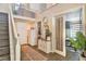 Inviting foyer with hardwood floors, decorative console table, and staircase leading to the second floor at 2497 Birch Hollow St, Henderson, NV 89044