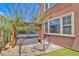 Backyard hot tub with shade covering, adjacent to artificial turf and landscaping at 2497 Birch Hollow St, Henderson, NV 89044