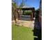Backyard hot tub in a covered gazebo with artificial grass at 2497 Birch Hollow St, Henderson, NV 89044