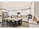 Spacious kitchen with a large center island, white cabinets, and stainless steel appliances at 2497 Birch Hollow St, Henderson, NV 89044