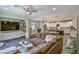 Open-concept living room and kitchen featuring modern finishes and a large, comfortable sectional sofa at 2497 Birch Hollow St, Henderson, NV 89044