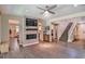 Open-concept living room featuring a stone fireplace and staircase at 2497 Birch Hollow St, Henderson, NV 89044