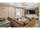 Relaxing living room with a large sectional sofa, natural light, and stylish accents at 2497 Birch Hollow St, Henderson, NV 89044