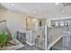 Spacious loft area overlooking the entryway, features a hanging chair, a bookshelf, and a railing at 2497 Birch Hollow St, Henderson, NV 89044