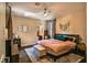 Comfortable main bedroom featuring a ceiling fan, ensuite bathroom, and neutral decor at 2497 Birch Hollow St, Henderson, NV 89044
