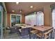 Covered patio featuring comfortable seating, a ceiling fan and a dining table at 2497 Birch Hollow St, Henderson, NV 89044