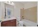 Traditional bathroom featuring a tiled shower-tub combo and a dark wood vanity with a sink at 2753 Kildrummie St, Henderson, NV 89044