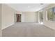 A bedroom with neutral walls and carpets, a window, and sliding glass doors at 2753 Kildrummie St, Henderson, NV 89044