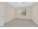 Light and airy carpeted bedroom with neutral walls and window at 2753 Kildrummie St, Henderson, NV 89044
