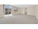 Spacious bedroom with neutral carpet, large windows, and sliding glass door leading to outdoor balcony at 2753 Kildrummie St, Henderson, NV 89044