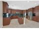 Spacious kitchen boasts stainless steel appliances, center island, and tile flooring at 2753 Kildrummie St, Henderson, NV 89044