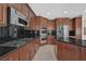 Gourmet kitchen with granite counters, stainless appliances, and a gas cooktop at 2753 Kildrummie St, Henderson, NV 89044