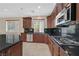Well-equipped kitchen with dark cabinets, granite countertops, and modern appliances at 2753 Kildrummie St, Henderson, NV 89044
