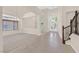 Inviting living room showcasing tile floors, soaring ceilings, and a staircase at 2753 Kildrummie St, Henderson, NV 89044