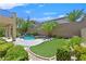Private backyard oasis with a sparkling pool, spa, lush landscaping, and an artificial turf at 2753 Kildrummie St, Henderson, NV 89044