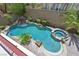 Aerial view of a private backyard pool, spa, and a waterfall feature amidst lush landscaping at 2753 Kildrummie St, Henderson, NV 89044