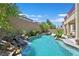 Stunning pool area showcasing a serene waterfall, shimmering pool, and plenty of lush landscaping at 2753 Kildrummie St, Henderson, NV 89044