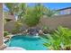 Resort-style pool area boasting a rock waterfall feature, lush landscaping, and a pristine pool at 2753 Kildrummie St, Henderson, NV 89044
