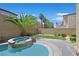 Backyard offers a tranquil pool, a raised spa, desert landscaping, and privacy fencing at 2753 Kildrummie St, Henderson, NV 89044