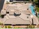 Aerial view of the home showcasing the intricate roof design, backyard pool, and lush landscaping at 277 Dark Forest Ave, Las Vegas, NV 89123