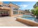Expansive backyard with sparkling pool, spa, and covered patio is ideal for outdoor living and entertaining at 277 Dark Forest Ave, Las Vegas, NV 89123