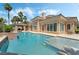 Beautiful backyard features a sparkling pool, spa, and covered outdoor kitchen, perfect for entertaining guests at 277 Dark Forest Ave, Las Vegas, NV 89123